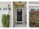Welcoming front entryway with a black door, lantern, and well-maintained landscaping at 160 Chandler Springs Dr, Holly Springs, NC 27540