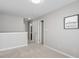 Neutral hallway features fresh paint and carpet, leading to various rooms in the home at 160 Chandler Springs Dr, Holly Springs, NC 27540