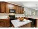 A kitchen featuring wooden cabinets, modern appliances, and a center island with quartz countertops at 160 Chandler Springs Dr, Holly Springs, NC 27540