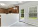 Eat-in kitchen area with wood cabinets, door to back yard at 160 Chandler Springs Dr, Holly Springs, NC 27540