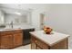 Bright kitchen with light countertops, island, and dark wood cabinets at 160 Chandler Springs Dr, Holly Springs, NC 27540