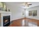 Bright living room featuring hardwood floors, fireplace, and natural light from the window at 160 Chandler Springs Dr, Holly Springs, NC 27540