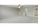 Spacious primary bedroom with carpet, ceiling fan, and multiple entryways at 160 Chandler Springs Dr, Holly Springs, NC 27540