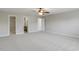 Spacious primary bedroom with carpet, ceiling fan, and multiple entryways at 160 Chandler Springs Dr, Holly Springs, NC 27540