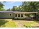 Backyard with lush greenery, a covered parking area, and a partially fenced yard at 1605 Nixon St, Durham, NC 27707