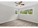 Bedroom featuring hardwood floors, ceiling fan, and large windows with natural light at 1605 Nixon St, Durham, NC 27707