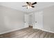 Bedroom featuring hardwood floors, fresh paint, two doors, a ceiling fan, and trim at 1605 Nixon St, Durham, NC 27707