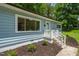 Close up exterior showcasing manicured landscaping, front stairs, and light blue facade at 1605 Nixon St, Durham, NC 27707