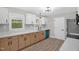 Bright kitchen featuring white cabinets, wood-tone lower cabinets, modern countertops, and stainless steel appliances at 1605 Nixon St, Durham, NC 27707