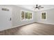 Living room featuring hardwood floors, large window with natural light, and entry door at 1605 Nixon St, Durham, NC 27707