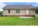 A backyard featuring a patio, grassy area, vinyl siding and brick foundation at 161 Bridgewater Dr, Erwin, NC 28339
