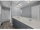 Bathroom featuring double sinks, vanity lighting, framed mirror, and a shower-tub combination at 161 Bridgewater Dr, Erwin, NC 28339