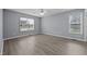Bright bedroom with laminate flooring, two windows, and neutral walls, creating a cozy atmosphere at 161 Bridgewater Dr, Erwin, NC 28339