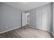 A well-lit bedroom featuring a closet, contemporary hard surface flooring and fresh gray paint at 161 Bridgewater Dr, Erwin, NC 28339