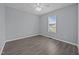 Neutrally decorated bedroom with a ceiling fan and a large window bringing in natural light at 161 Bridgewater Dr, Erwin, NC 28339