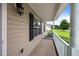 Covered front porch featuring a white railing and view of a green yard at 161 Bridgewater Dr, Erwin, NC 28339