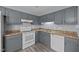 Charming kitchen with grey cabinets, white appliances, and laminate countertops at 161 Bridgewater Dr, Erwin, NC 28339