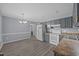 Well-lit kitchen showcasing grey cabinetry, white appliances, and wood-look floors at 161 Bridgewater Dr, Erwin, NC 28339