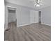 Serene main bedroom with laminate floors, ceiling fan, two windows, and convenient access to the ensuite bathroom at 161 Bridgewater Dr, Erwin, NC 28339
