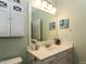 Bathroom with updated sink, vanity, decorative mirror, and white cabinets at 1911 Kudrow Ln, Morrisville, NC 27560