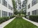 Exterior shot of condo community featuring a sidewalk and well-manicured lawn at 1911 Kudrow Ln, Morrisville, NC 27560