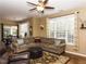 Open living space featuring a large sectional, ceiling fan, and view of dining area at 1911 Kudrow Ln, Morrisville, NC 27560