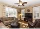 Bright living room with large windows, ceiling fan, and comfortable seating at 1911 Kudrow Ln, Morrisville, NC 27560