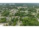 An aerial shot of a neighborhood shows roadways, green trees, and varying rooftops and buildings at 1920 Hart St, Durham, NC 27703