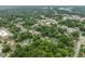 An aerial shot of a neighborhood displays dense greenery and a mix of residential and commercial buildings at 1920 Hart St, Durham, NC 27703