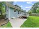 View of the back exterior of the house, showcasing a well-maintained backyard and a charming patio at 1920 Hart St, Durham, NC 27703