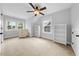 Bright bedroom featuring neutral walls, plush carpeting, ceiling fan, and natural light from a bank of windows at 1920 Hart St, Durham, NC 27703