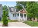 Charming two-story home with light blue siding, a welcoming front porch and beautiful landscaping at 1920 Hart St, Durham, NC 27703