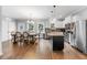 Modern kitchen featuring stainless steel appliances, granite countertops, and an open layout to the dining area at 1920 Hart St, Durham, NC 27703