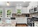 Well-equipped kitchen with stainless steel appliances, white cabinets, and granite countertops at 1920 Hart St, Durham, NC 27703