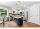 Bright kitchen with white cabinets, stainless steel appliances, granite countertops, and hardwood flooring at 1920 Hart St, Durham, NC 27703