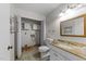 Bathroom with vanity and sink, toilet and shelves, ready for renovation at 204 Chatterson Dr, Raleigh, NC 27615