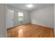 A bright bedroom featuring hardwood floors, a window, and closet at 204 Chatterson Dr, Raleigh, NC 27615