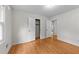 A bright bedroom featuring hardwood floors and a closet with double doors at 204 Chatterson Dr, Raleigh, NC 27615