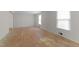 Spacious bedroom featuring two bright windows and unfinished floors at 204 Chatterson Dr, Raleigh, NC 27615