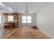 Open dining area with chandelier, unfinished floors, and adjacent space with window at 204 Chatterson Dr, Raleigh, NC 27615