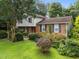 Charming home features a red front door, brick accents, mature landscaping, and lush green lawn at 204 Chatterson Dr, Raleigh, NC 27615