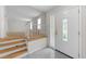 Entryway with tiled floor and white door with sidelight, leads to rooms with unfinished floors at 204 Chatterson Dr, Raleigh, NC 27615