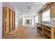 Unfinished kitchen/living area with exposed walls, uninstalled cabinets, with stairs in the background at 204 Chatterson Dr, Raleigh, NC 27615