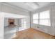 Bright living room with large windows and an open floor plan, ready to renovate at 204 Chatterson Dr, Raleigh, NC 27615
