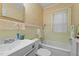 Clean bathroom with tub, shower, and a sink with a mirrored medicine cabinet at 212 Plum St, Burlington, NC 27215