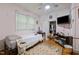 Comfortable bedroom with built-in storage, closet space, and natural light, perfect for relaxation at 212 Plum St, Burlington, NC 27215