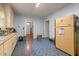 Well-lit kitchen with ample cabinetry, efficient layout, and space for meal preparation and storage at 212 Plum St, Burlington, NC 27215