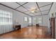 Bright living room with hardwood floors, a brick fireplace, coffered ceiling, and large windows for natural light at 212 Plum St, Burlington, NC 27215