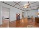 Spacious living room featuring hardwood floors, coffered ceiling, and a cozy brick fireplace at 212 Plum St, Burlington, NC 27215