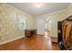 Bright office with floral wallpaper, hardwood flooring, and natural light at 212 Plum St, Burlington, NC 27215